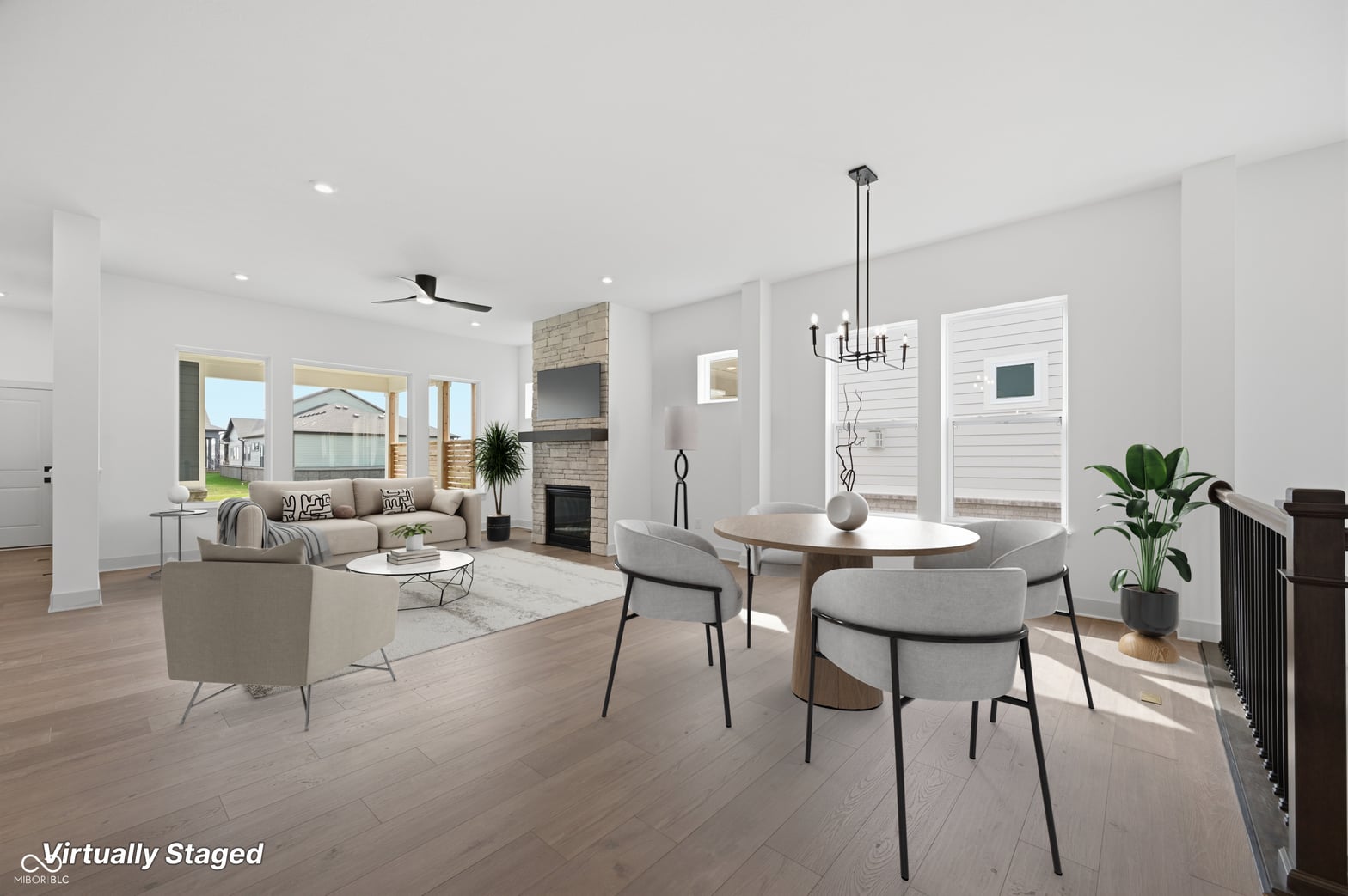 Bright open-concept living space with fireplace and dining area.