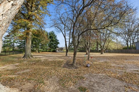 Yard at 1836 W Main Street, Carmel, IN — Spacious wooded lot with mature trees and open grounds.