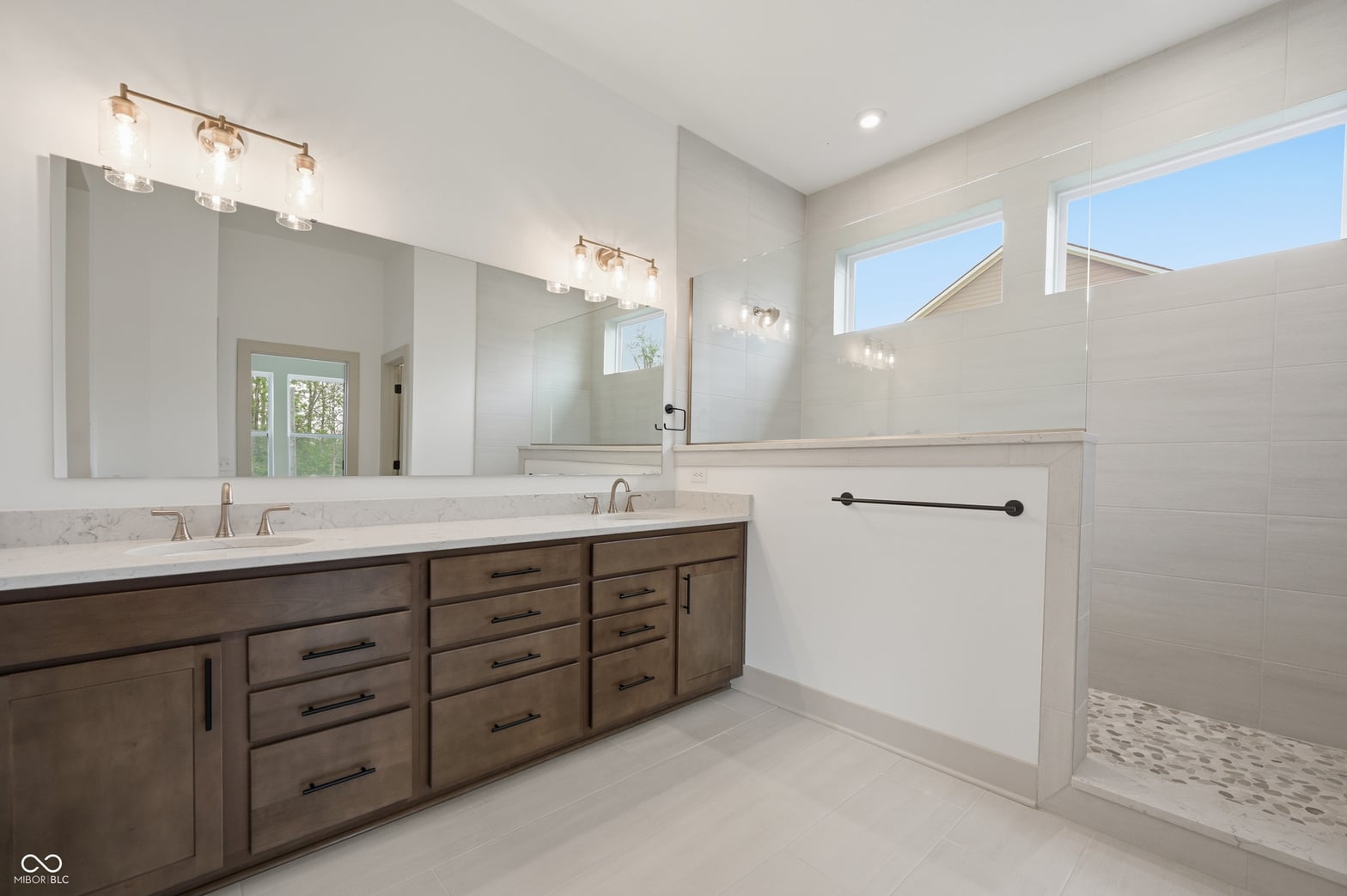 Spa-like primary bath with double vanity and luxury finishes.