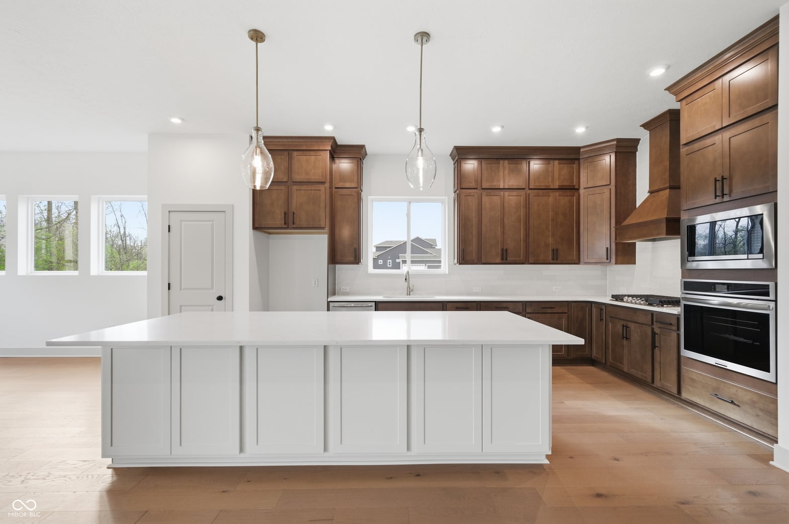 Spacious kitchen with two-tone cabinetry and premium appliances.