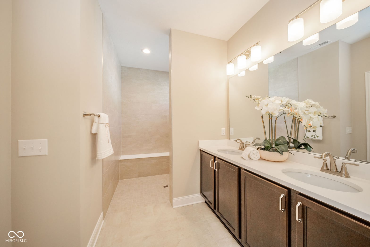 Spa-like primary bath with double vanity and walk-in shower.