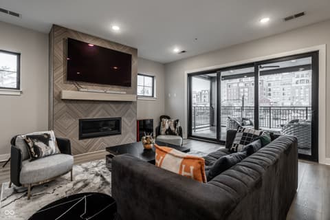 Living room at 705 Livingstone Drive, Carmel, IN — Modern living room with fireplace and city views.