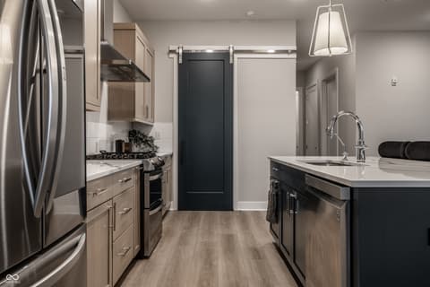 Kitchen at 705 Livingstone Drive, Carmel, IN — Modern kitchen with two-tone cabinetry and premium finishes.