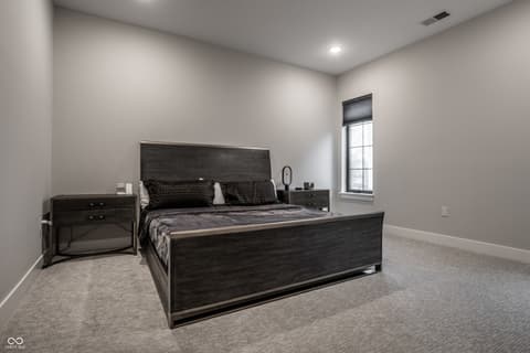 Primary bedroom at 705 Livingstone Drive, Carmel, IN — Spacious modern primary bedroom with neutral finishes.