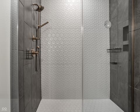 Primary bathroom at 705 Livingstone Drive, Carmel, IN — Luxury spa-like shower with designer hex tile.