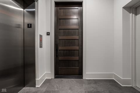 Foyer at 705 Livingstone Drive, Carmel, IN — Modern foyer with elevator access and sleek finishes.