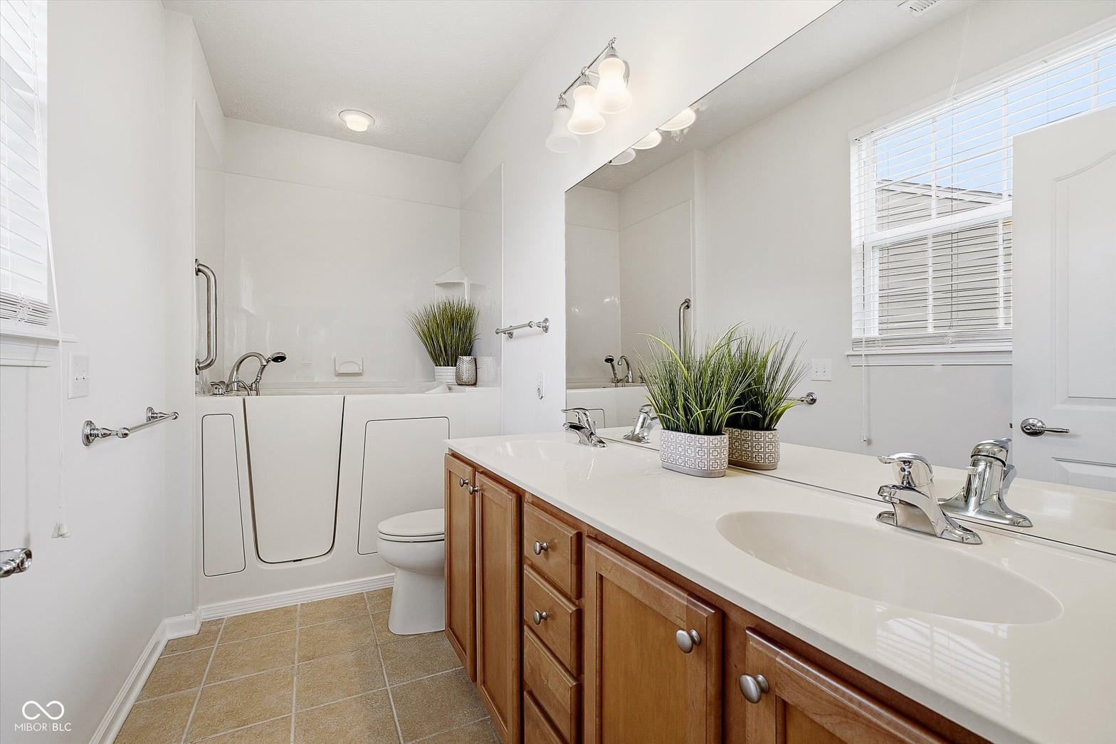 Spacious primary bath with dual vanity and walk-in shower.
