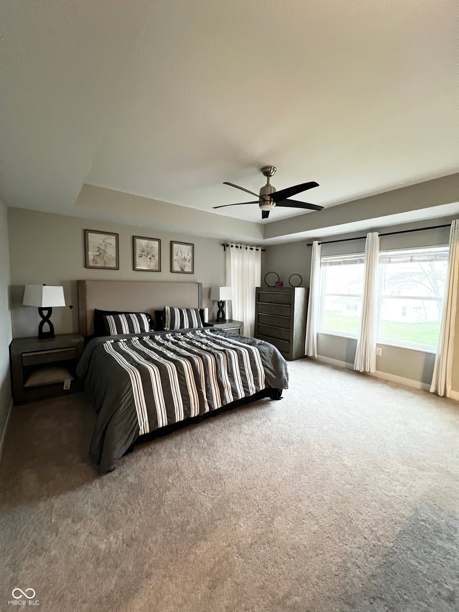 Spacious primary suite with natural light and patio access.