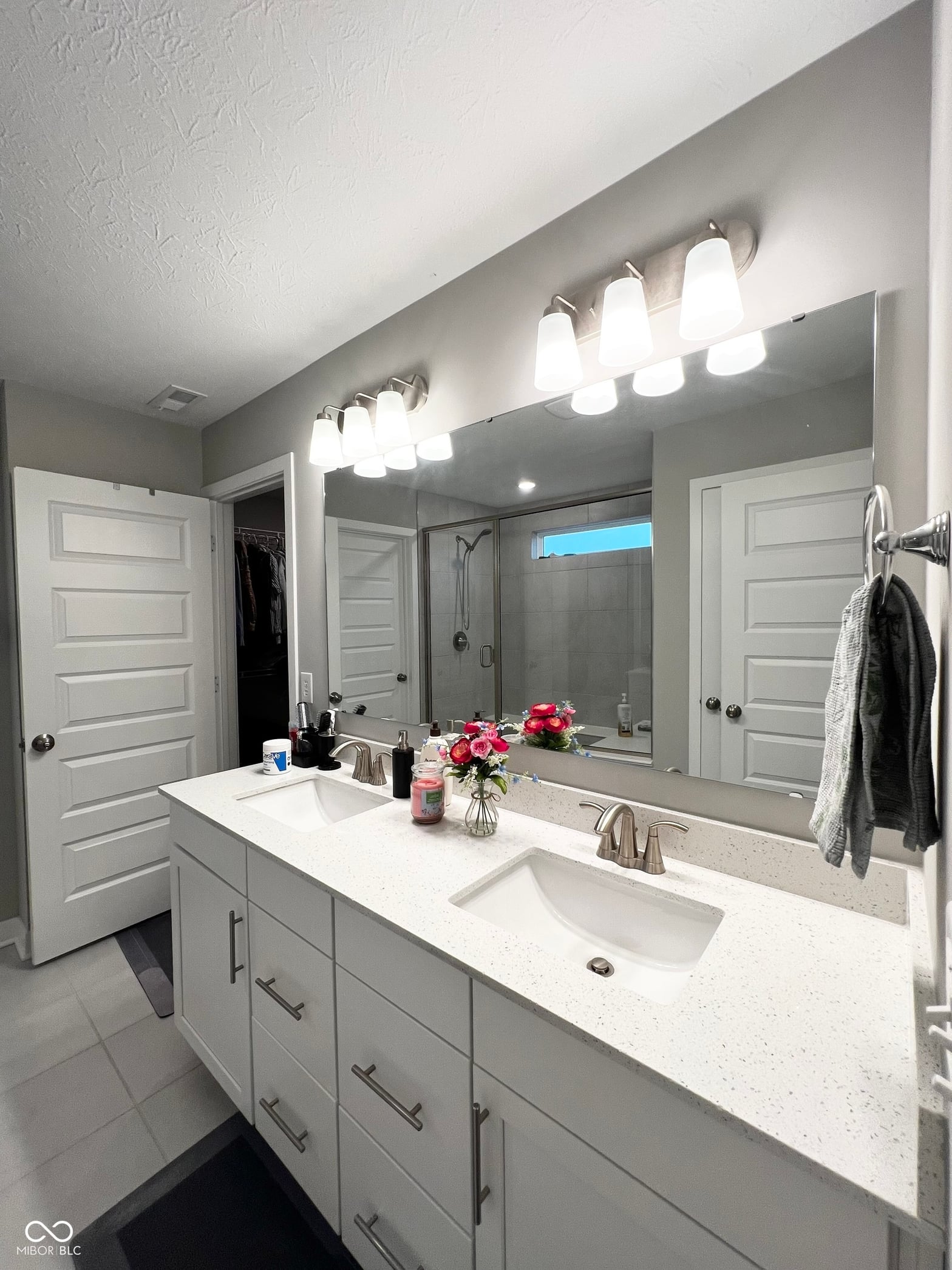 Luxurious primary bath with dual vanity and updated finishes.