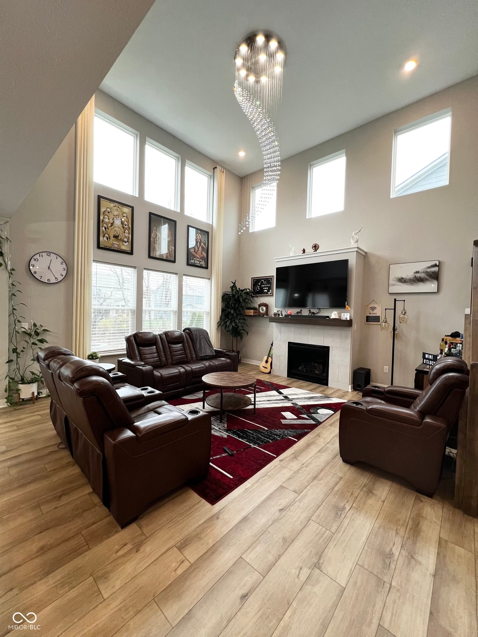 Stunning vaulted living room with crystal chandelier and fireplace.