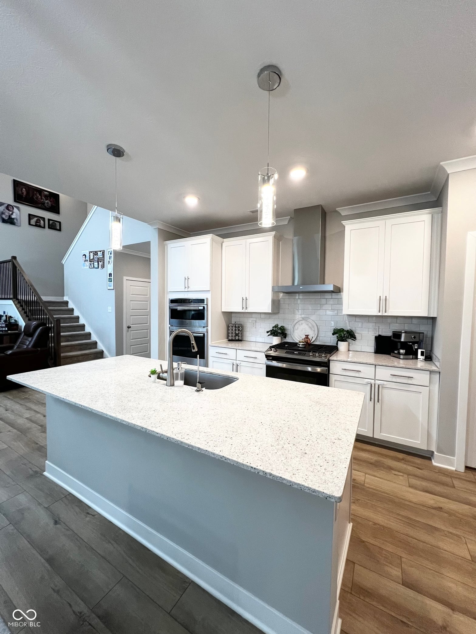 Modern kitchen with gleaming quartz island and premium appliances.