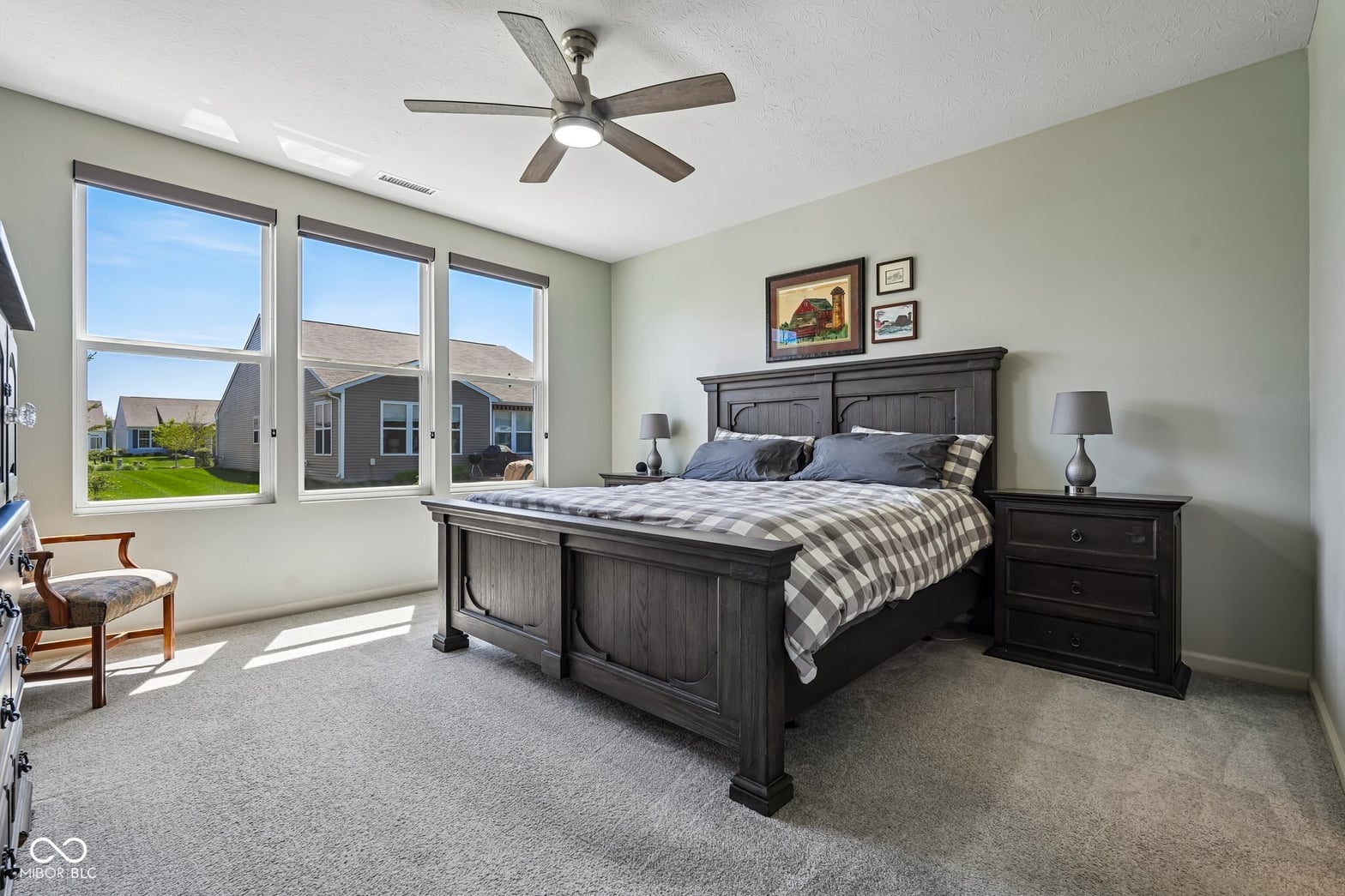 Spacious primary bedroom with abundant natural light.