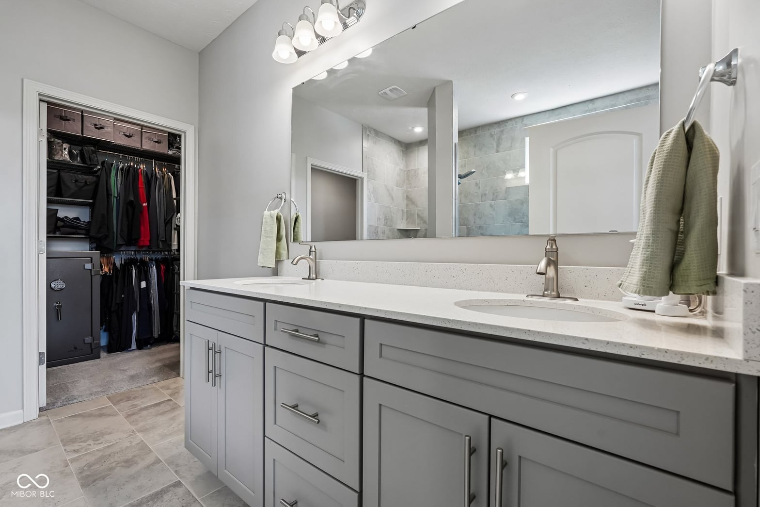 Spacious primary bath with dual vanity and walk-in closet.