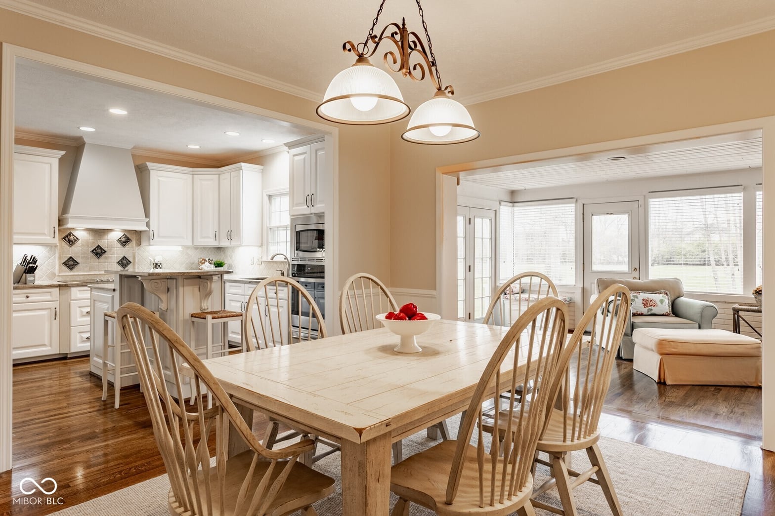 Bright traditional dining area with hardwood floors and natural light.