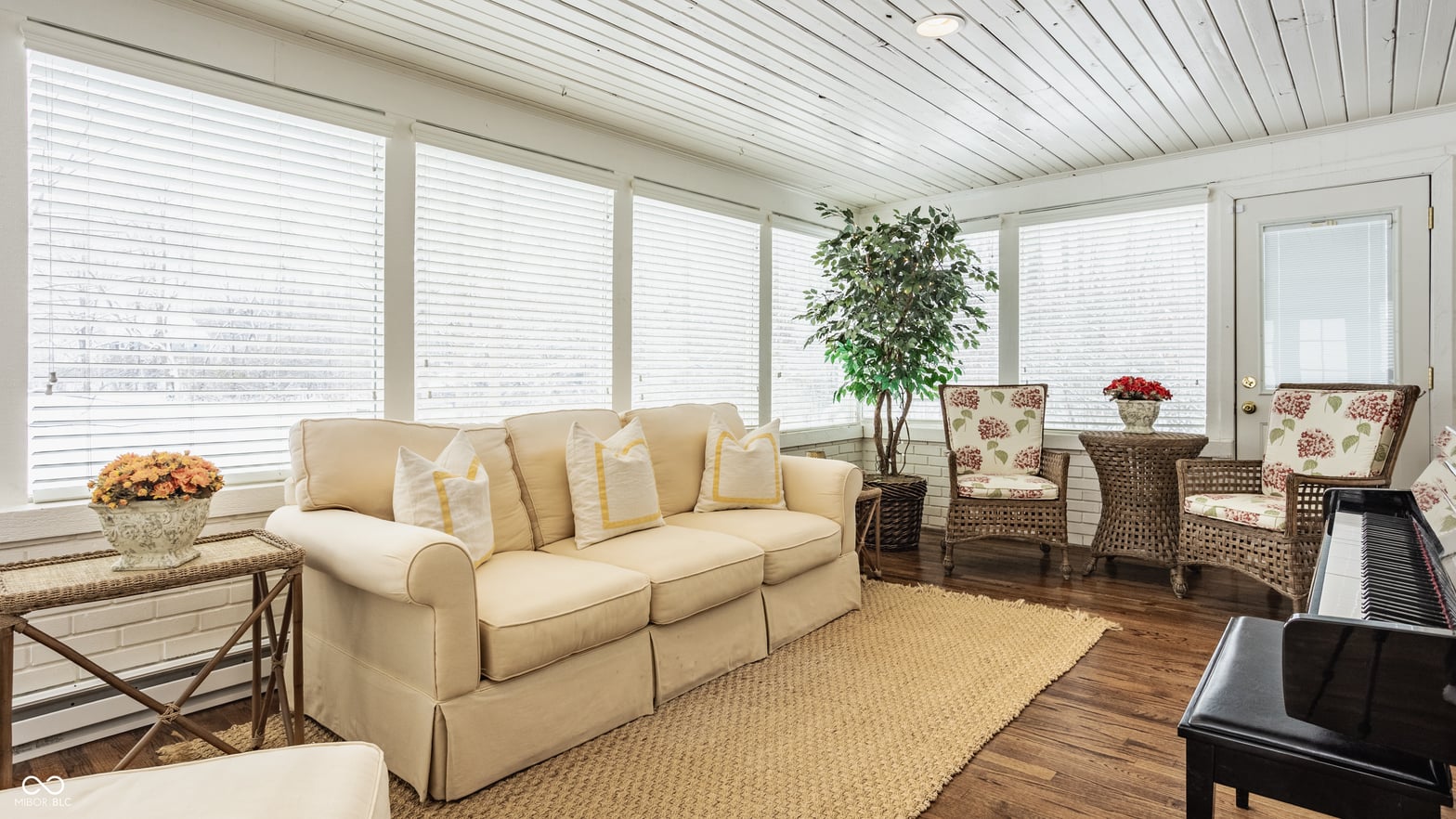 Bright family room with shiplap ceiling and abundant natural light.