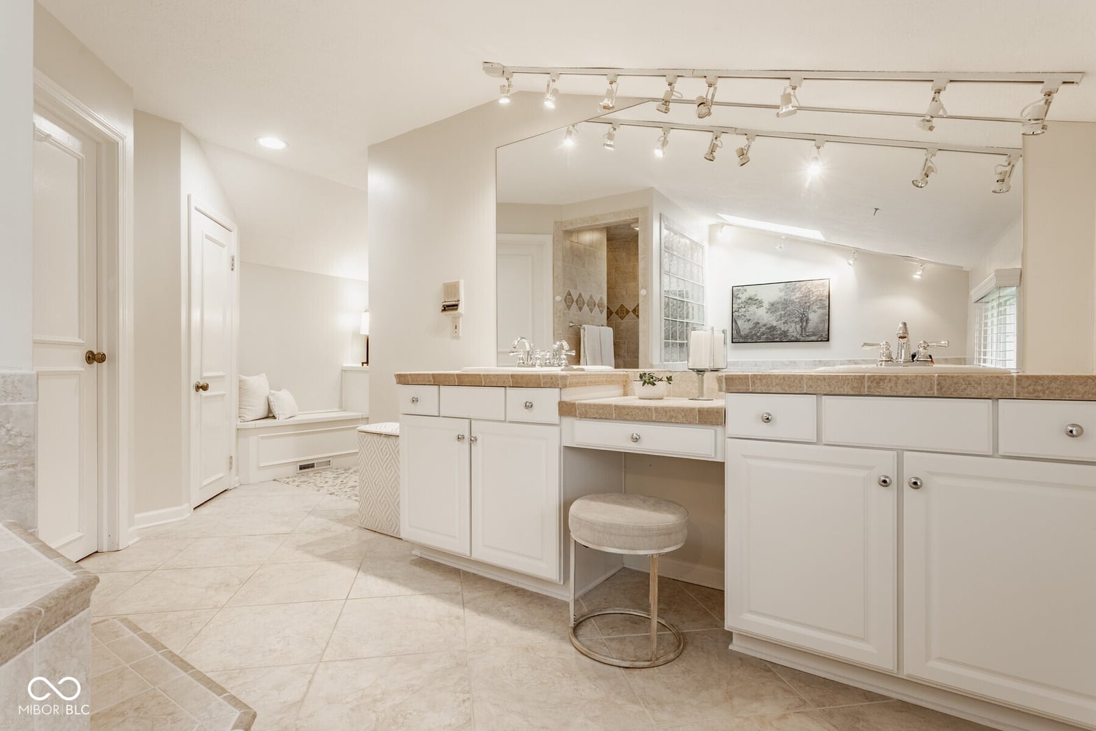 Luxurious primary bath with double vanity and spa features.