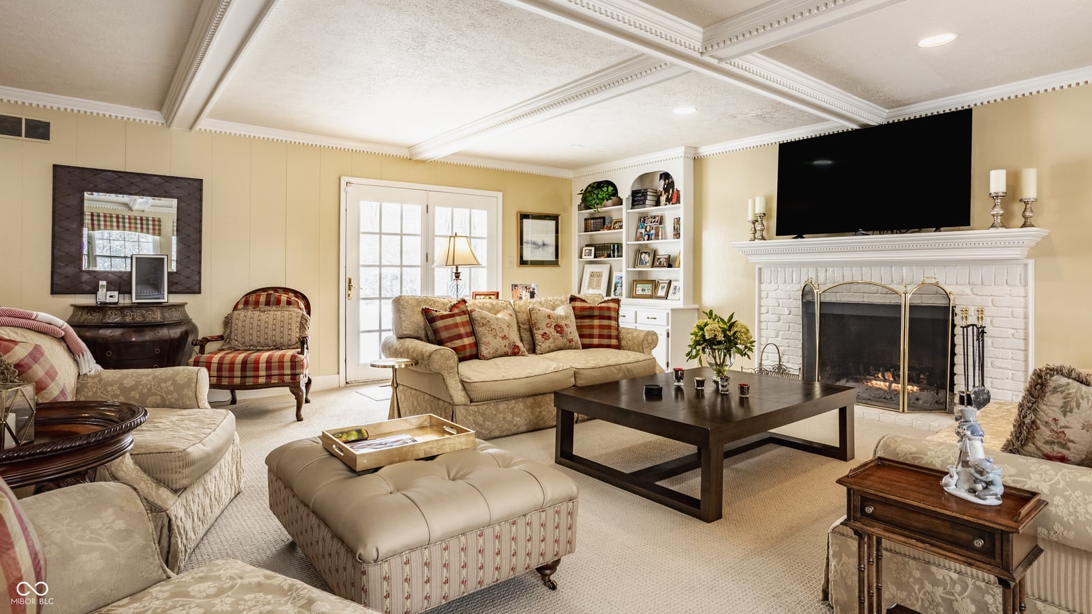 Elegant traditional living room with fireplace and coffered ceiling.
