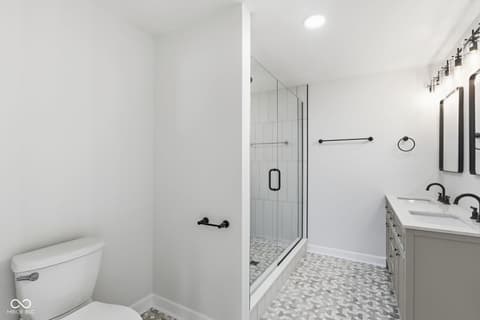 Primary bathroom at 4991 E Main Street, Carmel, IN — Spa-like primary bath with dual vanity and walk-in shower.