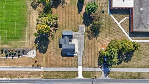 Aerial view at 4991 E Main Street, Carmel, IN — Spacious lot with mature trees and established landscaping.