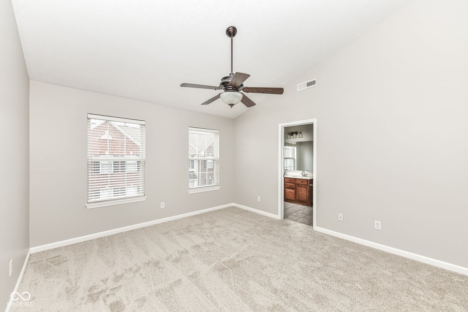 Spacious primary bedroom with ensuite access and abundant natural light.