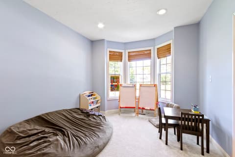 Bedroom at 14825 Latitude Way, Fishers, IN — Bright bedroom with bay window and versatile play space.