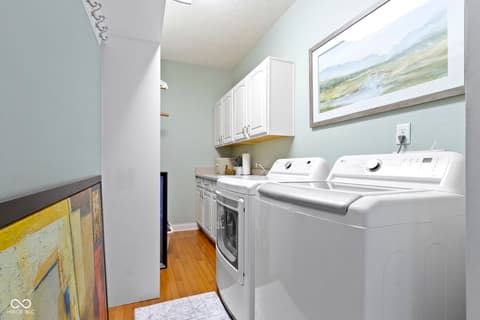 Laundry room at 14825 Latitude Way, Fishers, IN — Bright, organized laundry room with premium appliances.