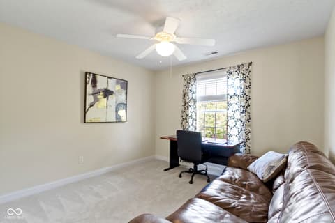Bedroom at 14825 Latitude Way, Fishers, IN — Spacious bedroom with dedicated work area and natural light.