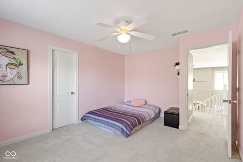 Bedroom at 14825 Latitude Way, Fishers, IN — Bright pink bedroom with spacious layout and natural light.