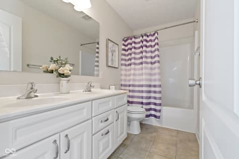 Primary bathroom at 14825 Latitude Way, Fishers, IN — Spacious primary bath with dual vanity and granite counters