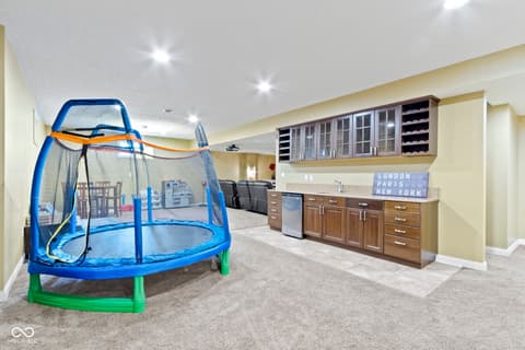 Basement at 14825 Latitude Way, Fishers, IN — Finished basement with wet bar and recreation space.