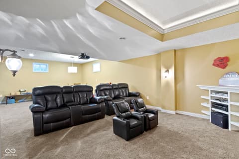 Basement at 14825 Latitude Way, Fishers, IN — Luxurious finished basement with home theater setup.