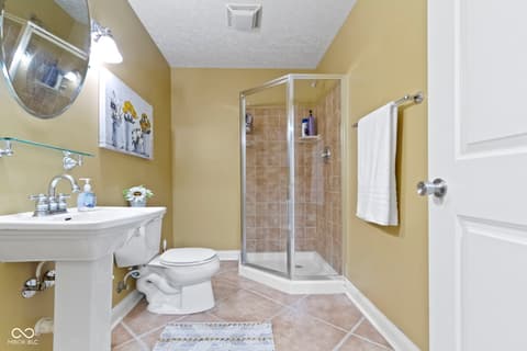 Primary bathroom at 14825 Latitude Way, Fishers, IN — Bright, spacious primary bath with modern shower enclosure.