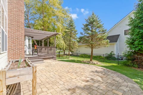 Outdoor living area at 14825 Latitude Way, Fishers, IN — Beautiful paver patio with covered pergola deck.