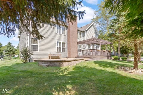 Backyard at 14825 Latitude Way, Fishers, IN — Spacious backyard with mature trees and updated deck.
