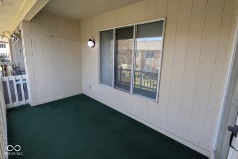 Outdoor living area at 586 Hunters Drive, Carmel, IN — Bright screened porch with views and modern finishes.