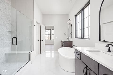 Primary bathroom at 16956 Tractive Drive, Westfield, IN — Luxurious primary bath with freestanding tub and spa shower.