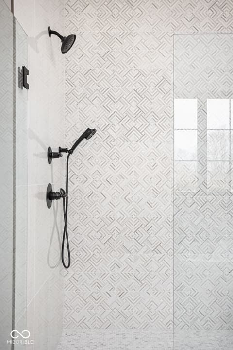 Primary bathroom at 16956 Tractive Drive, Westfield, IN — Luxurious spa-like shower with geometric tile design.