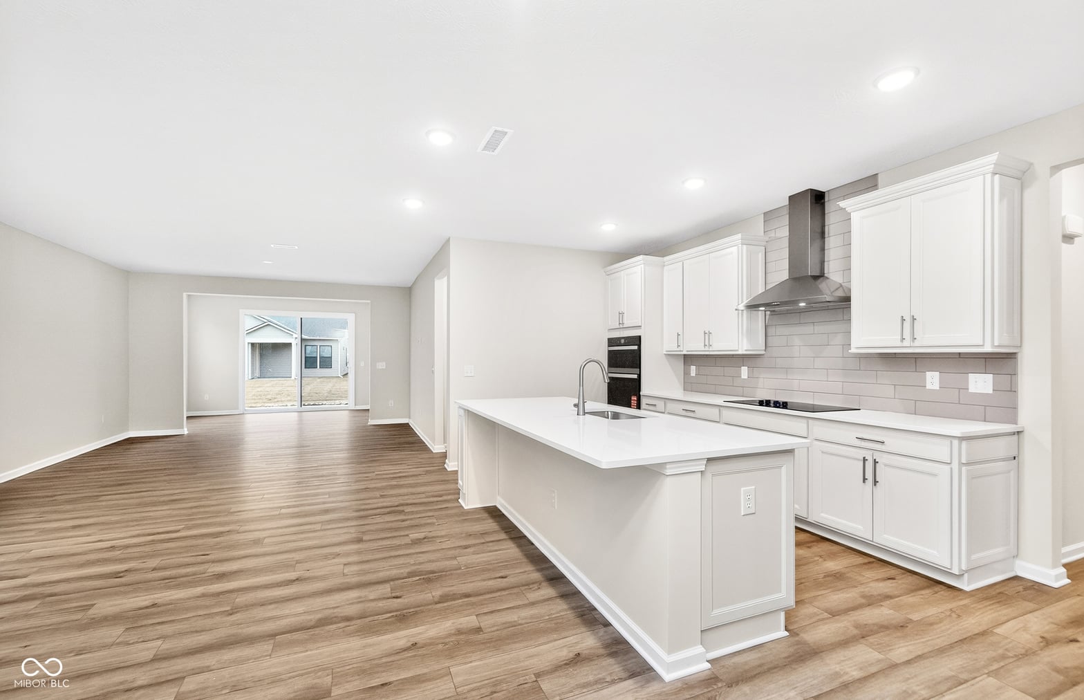 Bright modern kitchen with oversized island and quality finishes.