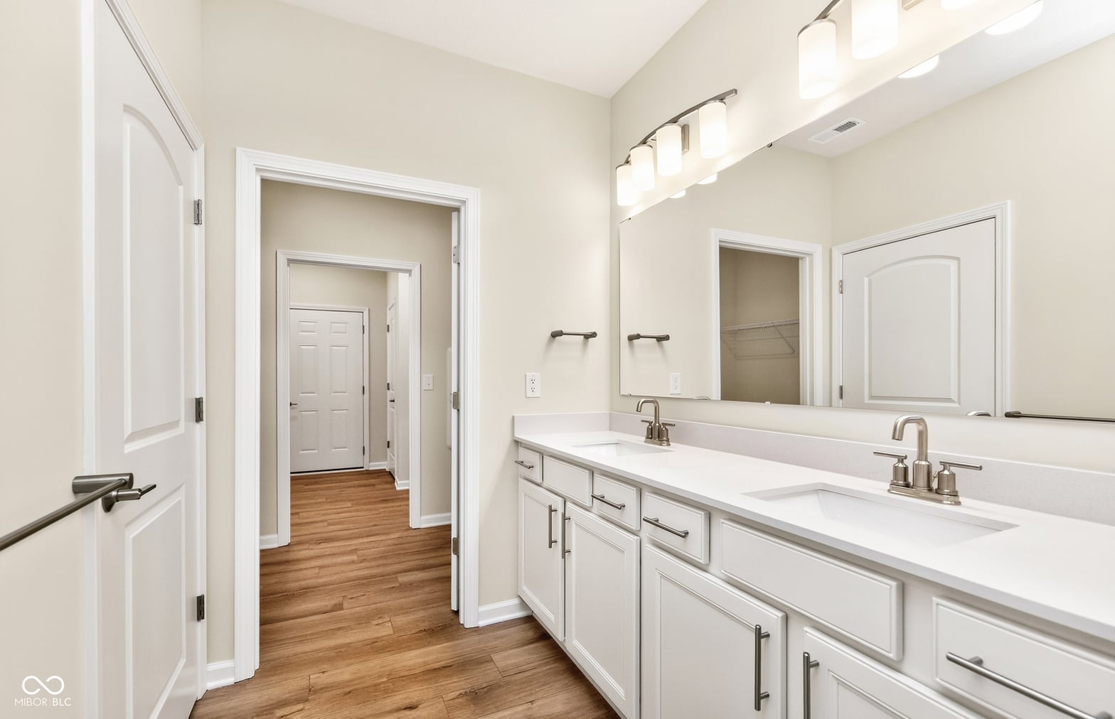 Spacious primary bath with dual vanity and quality finishes.