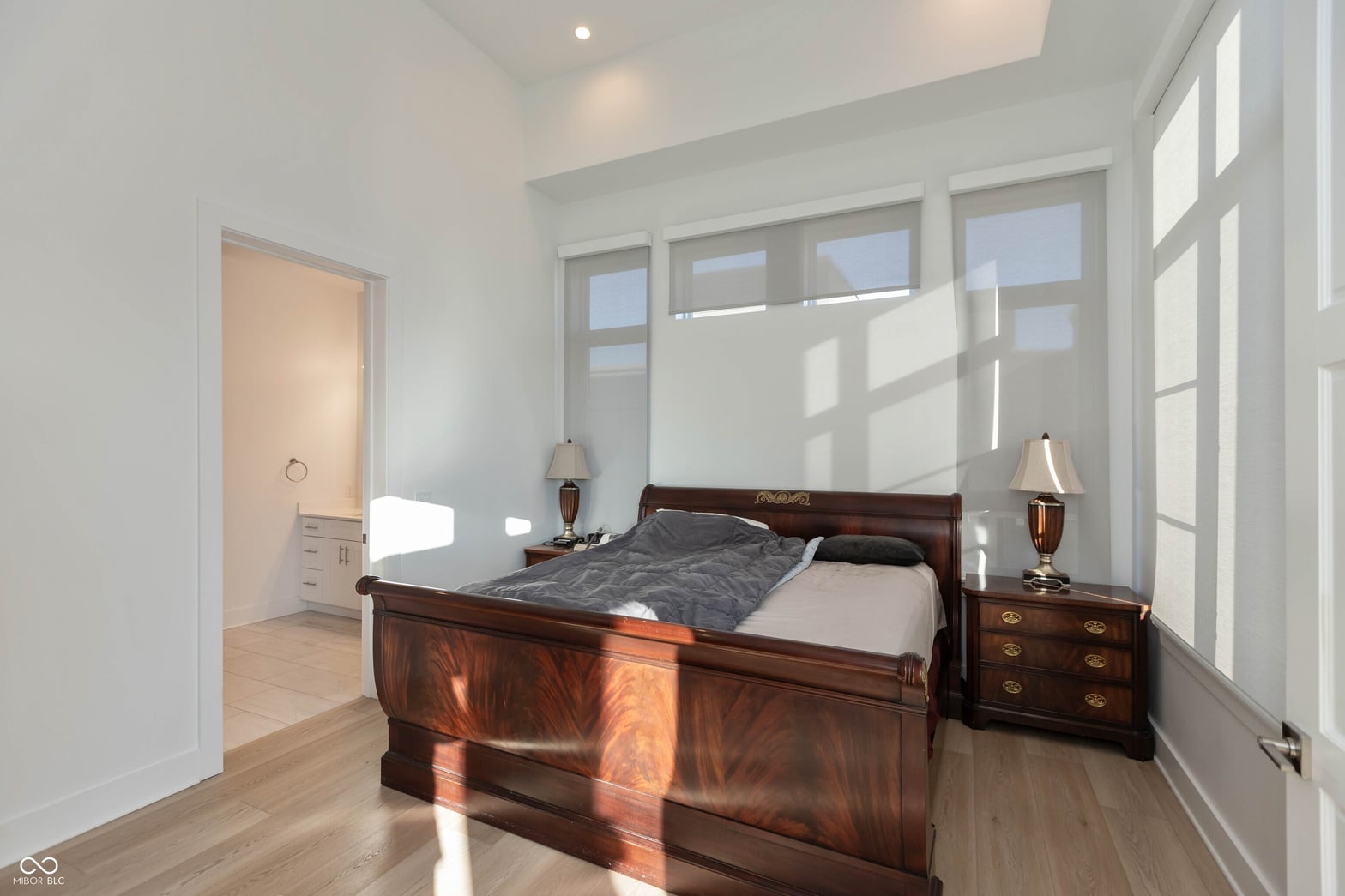 Bright primary suite with abundant natural light and hardwood floors.