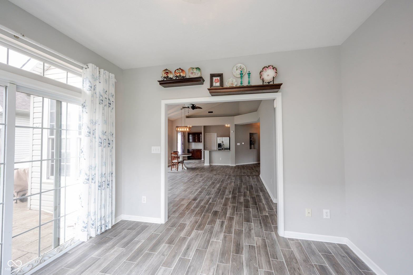Bright open concept living space with modern plank flooring.