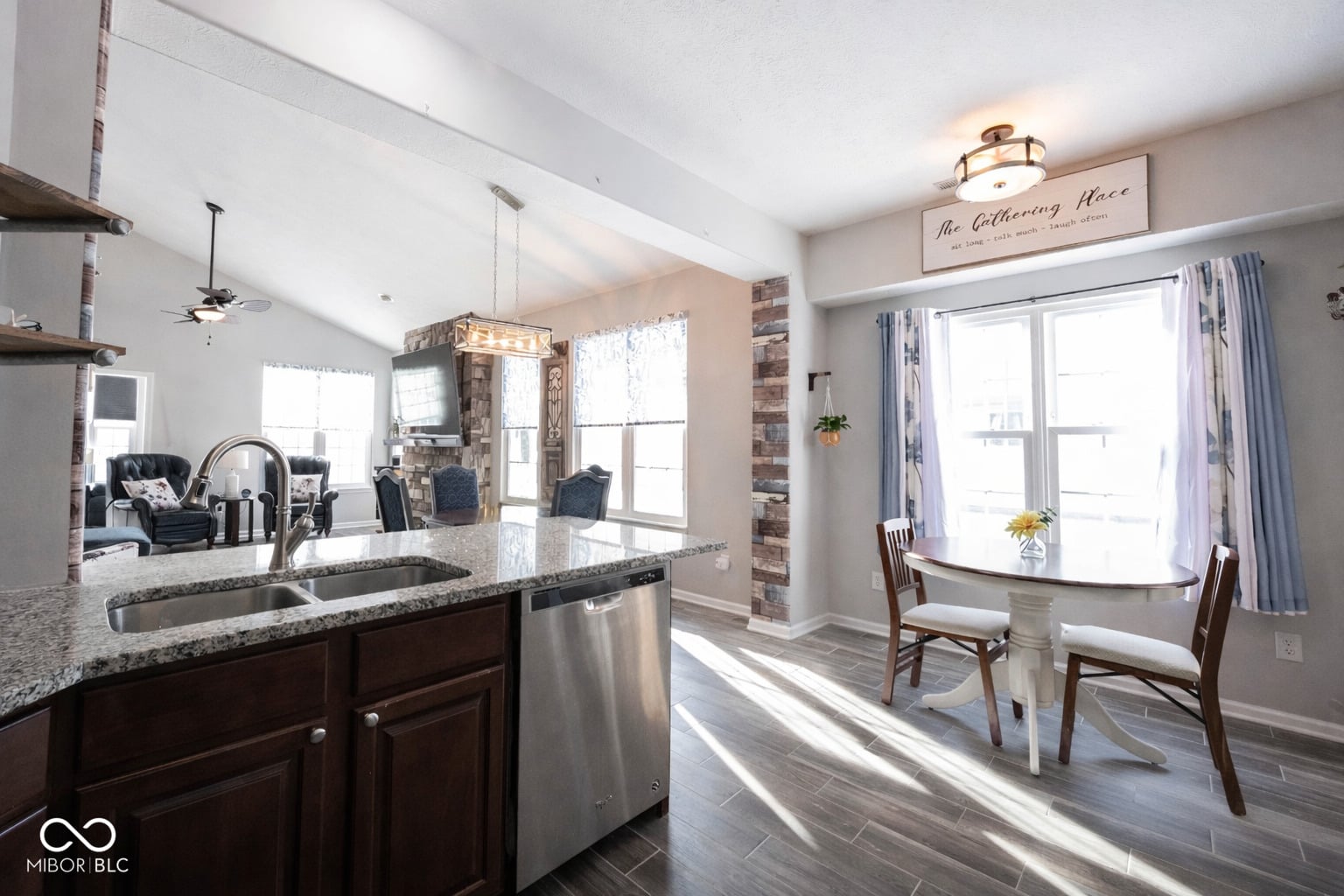 Bright open kitchen with granite and stainless steel.