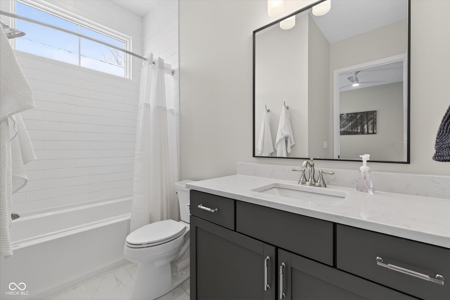 Modern primary bath with luxury finishes and natural light.