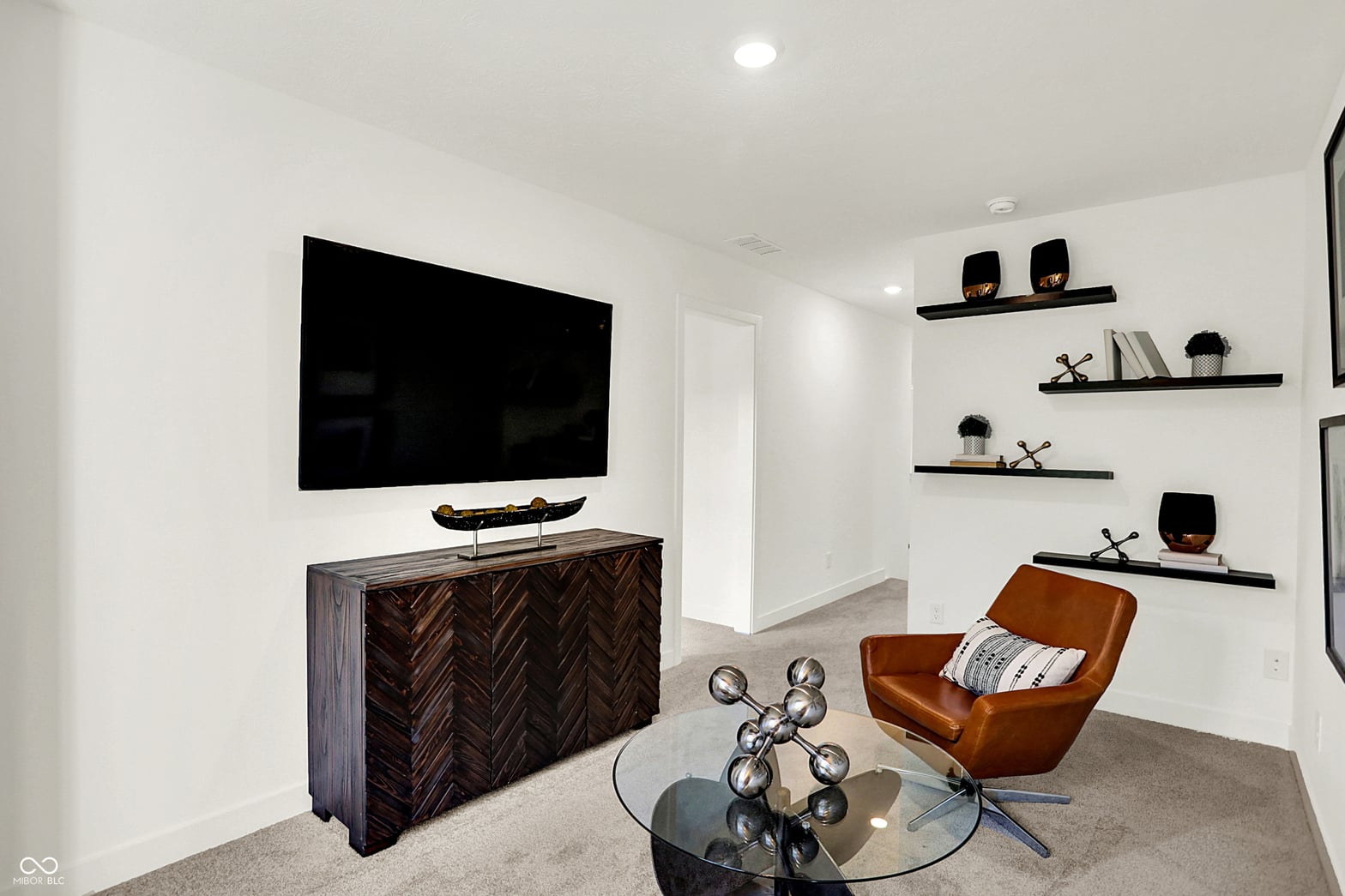 Modern media room with designer finishes and custom shelving.