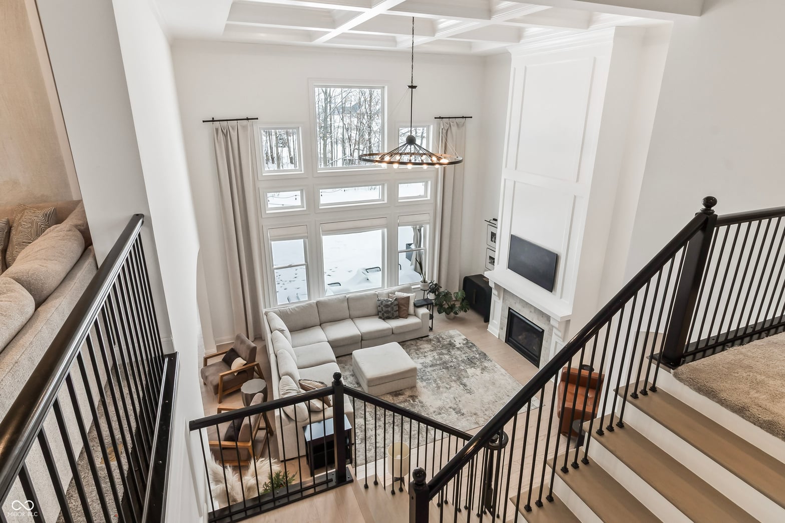 Bright two-story family room with fireplace and skylights.