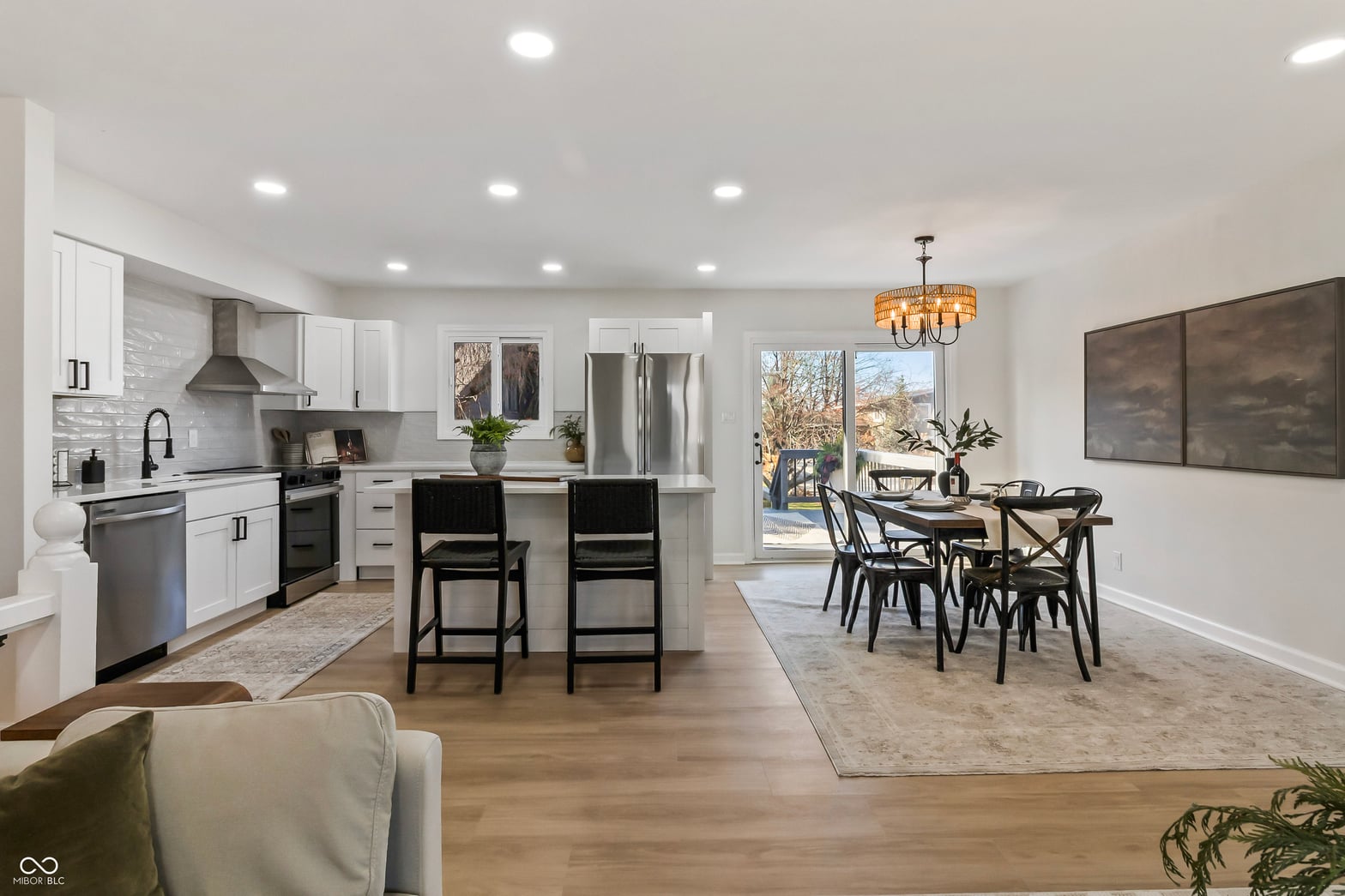 Modern renovated kitchen with island and open concept layout.