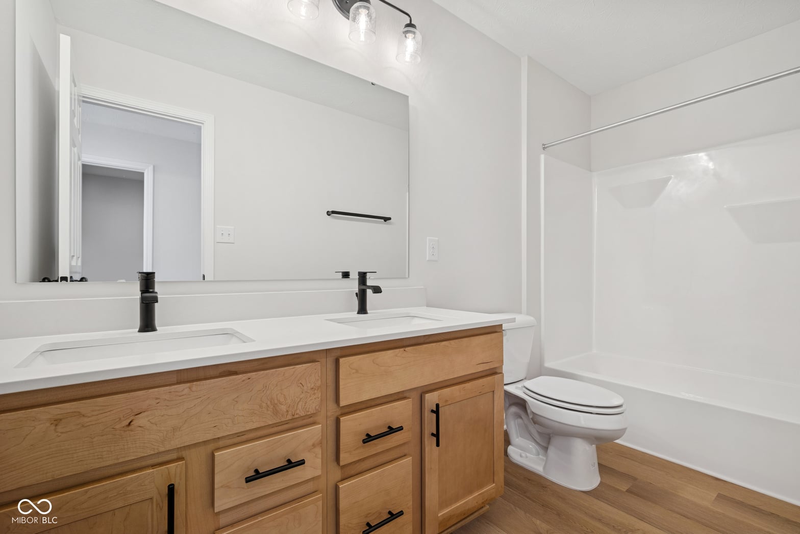 Modern primary bath with double vanity and updated finishes.