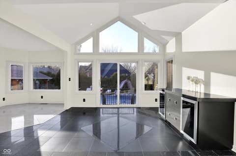 Kitchen at 434 Sheffield Court, Carmel, IN — Bright modern kitchen with vaulted ceilings and glass doors.