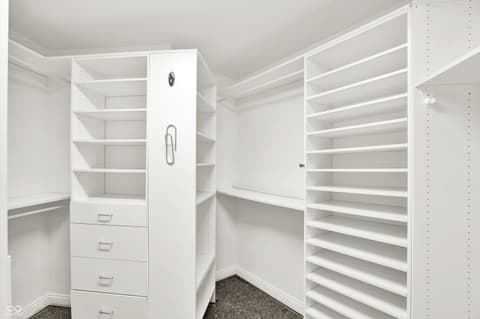 Primary bedroom at 434 Sheffield Court, Carmel, IN — Spacious walk-in closet with extensive built-in storage.