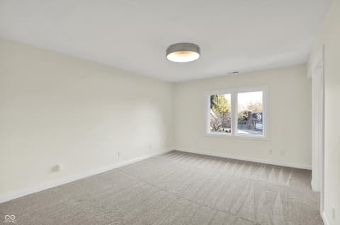 Bedroom at 434 Sheffield Court, Carmel, IN — Bright, spacious bedroom with abundant natural light.